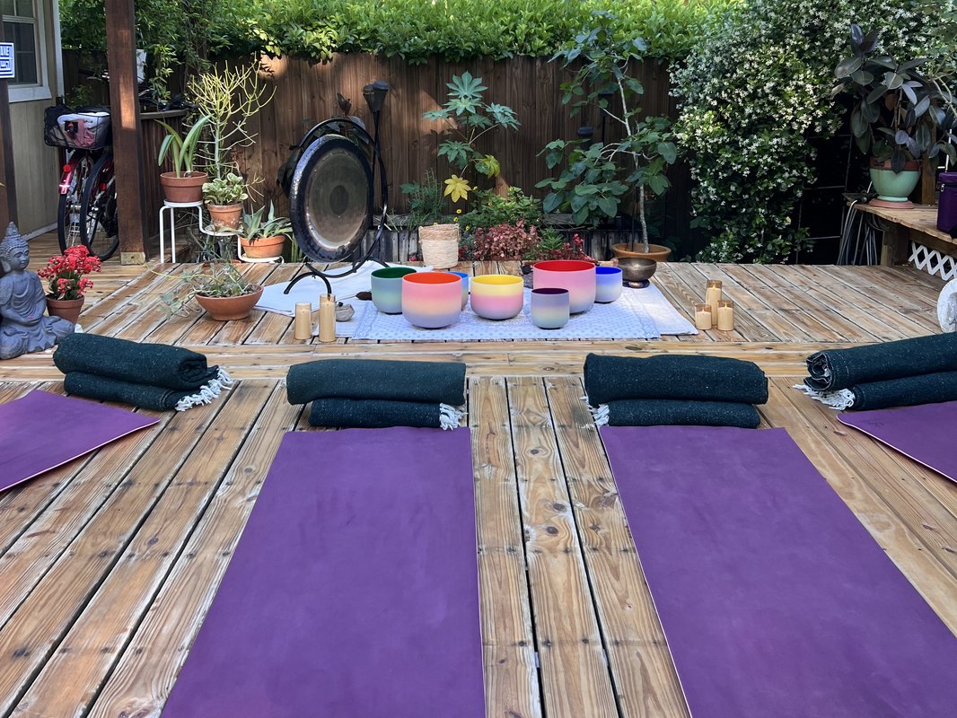 The deck set up with mats, blankets, crystal bowls and gong