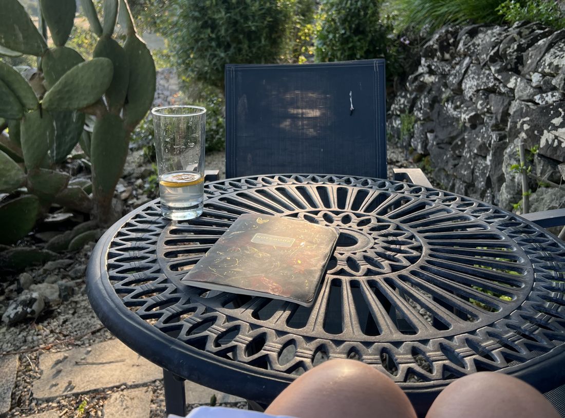 A quiet moment in the garden with the retreat notebook and a glass of water
